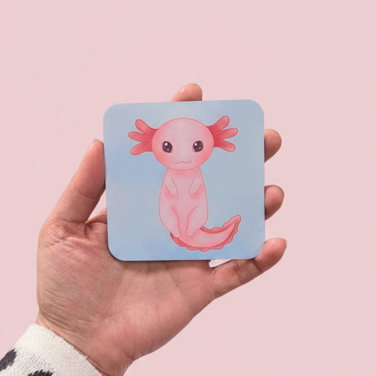 Hand holding a coaster with an axolotl illustration
