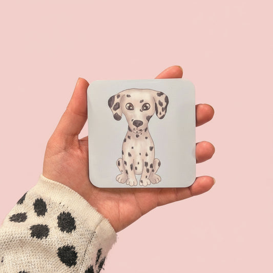 Hand holding a coaster with a cute dalmatian illustration design 